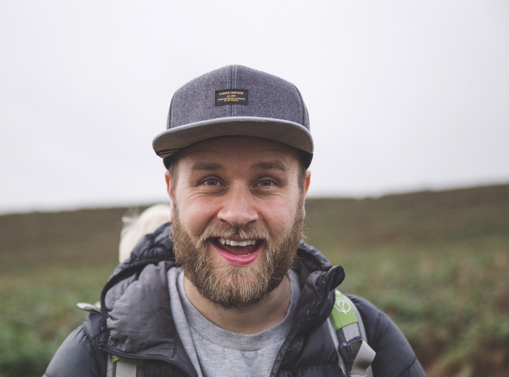Marc Wise smiling outdoors, wearing a cap and gilet